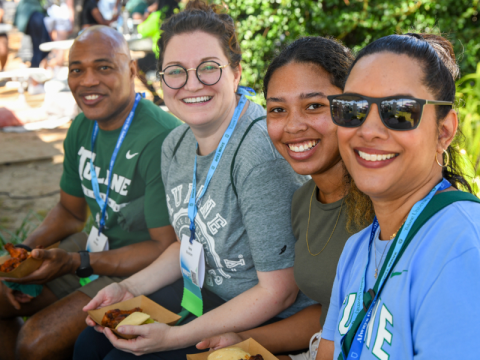Four people sitting at homecoming 
